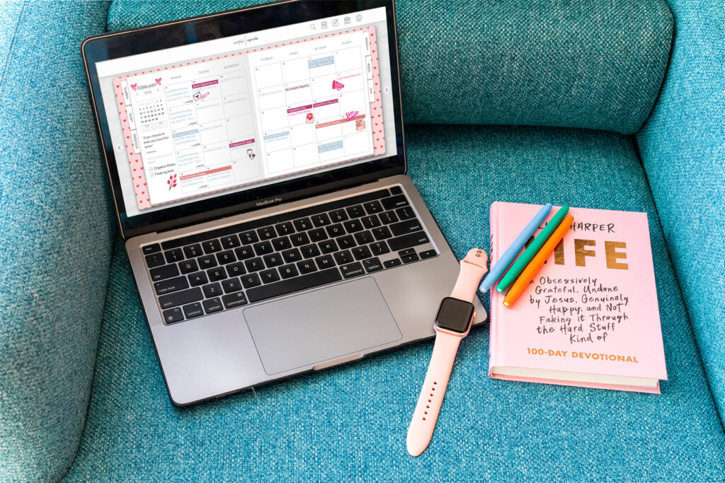 laptop and smart watch with notebook and pens 