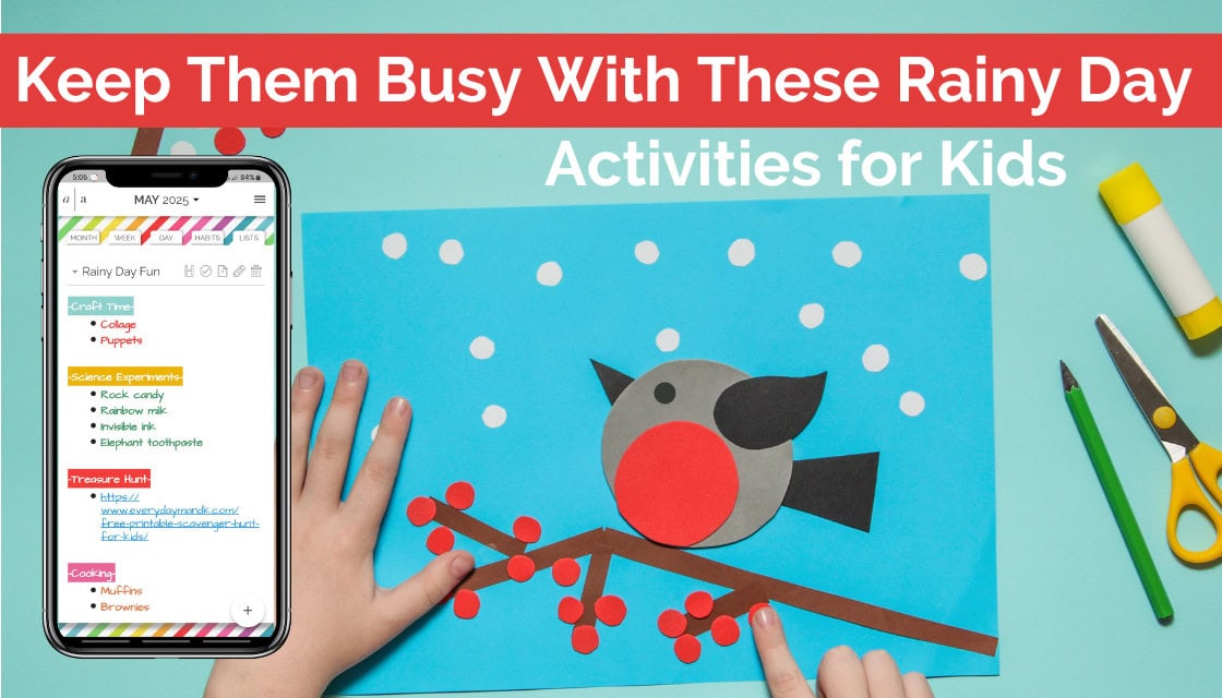 Child’s hands working on a bird-themed paper craft with a smartphone screen showing a digital planner titled “Rainy Day Fun” and a list of indoor kids’ activities.