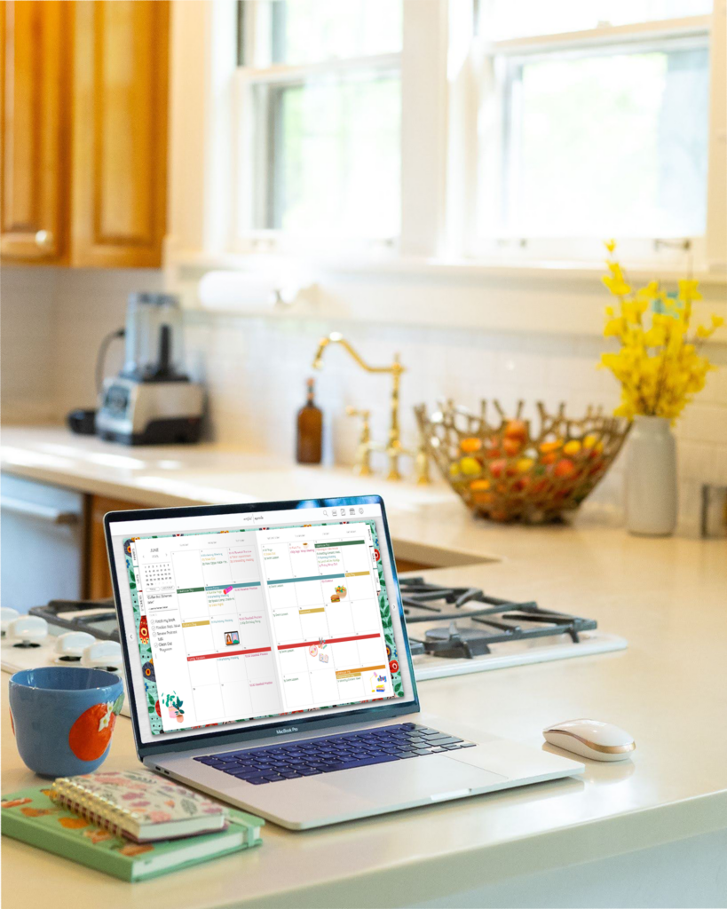 A colorful digital planner, Artful Agenda, open on the counter, showcasing an organized schedule with notes. This showcases effective time management for stay at home moms transitioning back to work.
